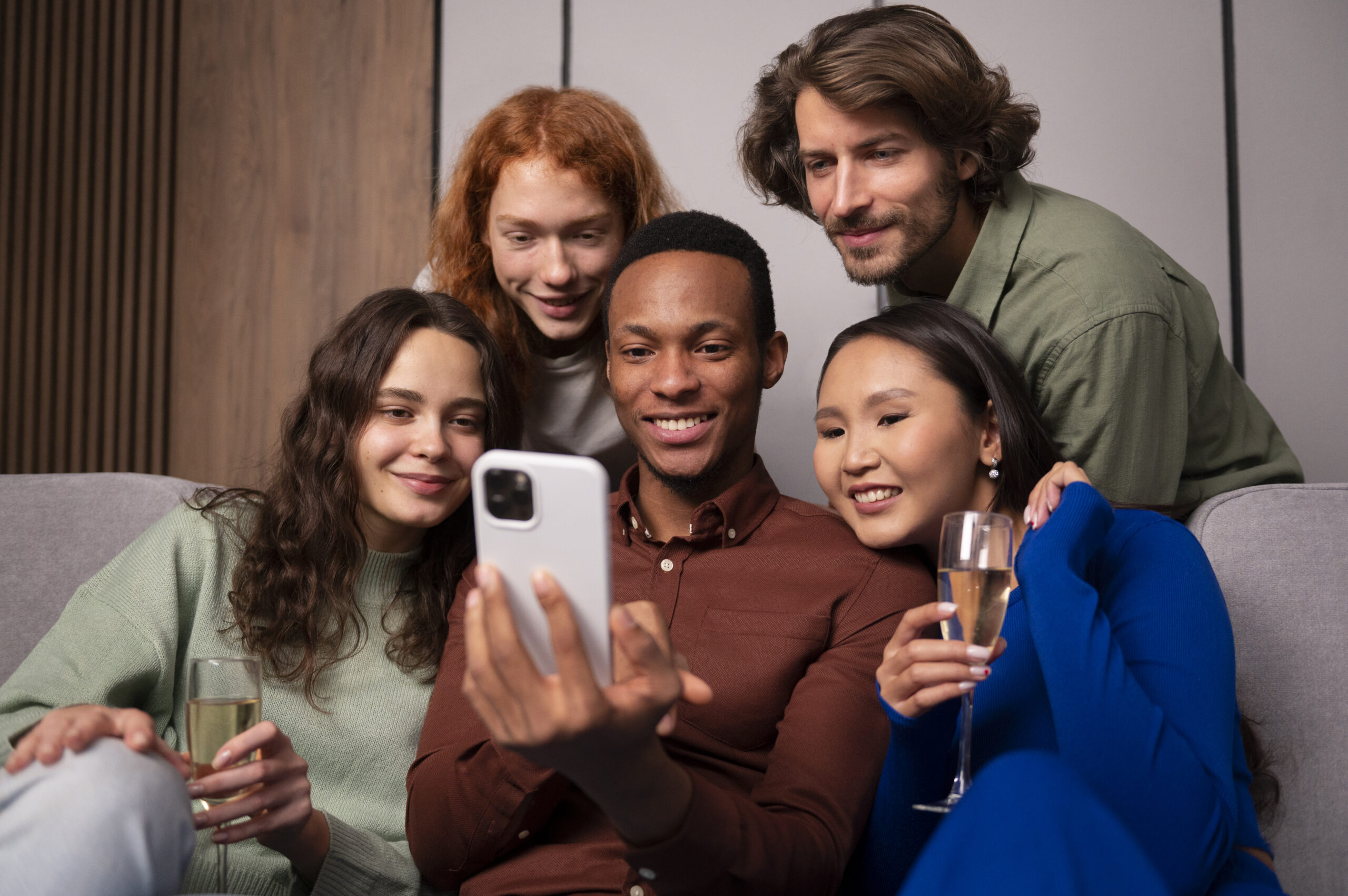 Group of friends laughing and holding phones with the UpSwap app logo displayed.