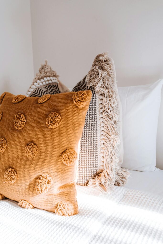 DIY Home Decor Teenager customizing a throw pillow with fabric scraps and colorful buttons
