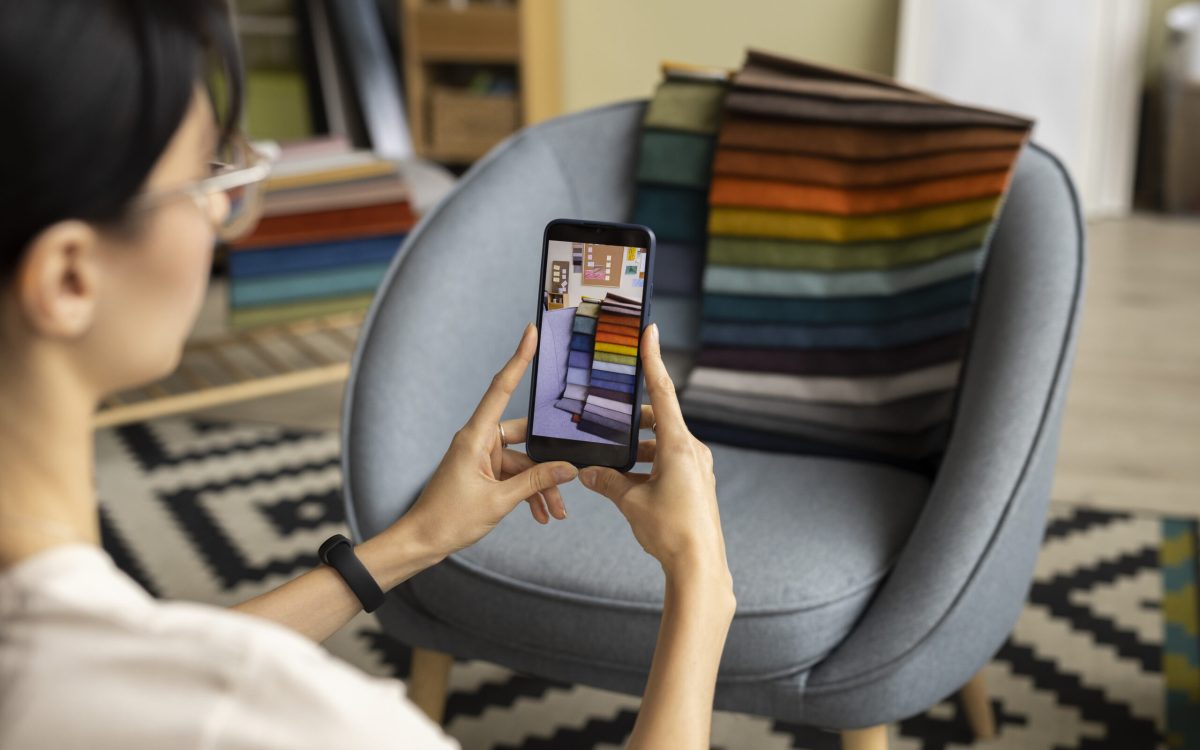 Teenager using a smartphone app (Upswap) to browse clothing while sitting on a couch.